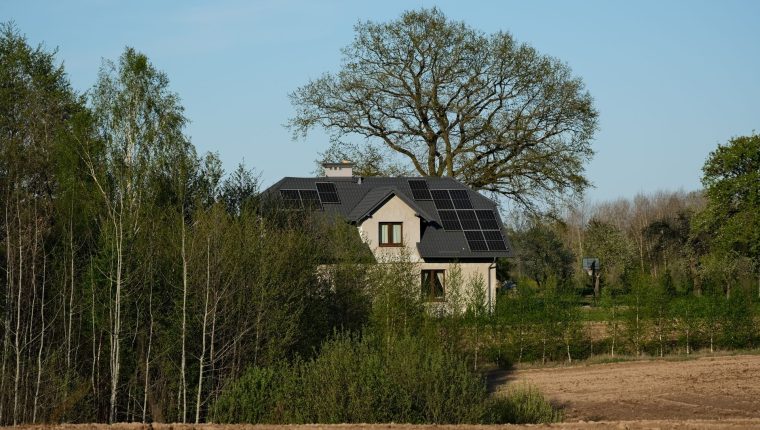 sustainable home with solar panels in nature