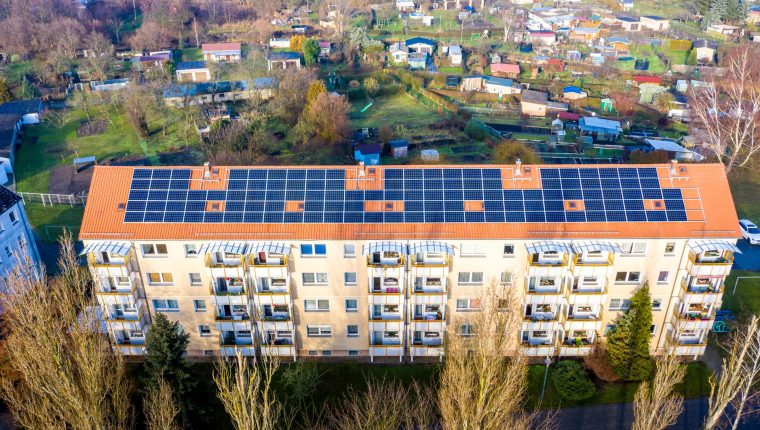 drone shot of a building with solar panels on roof