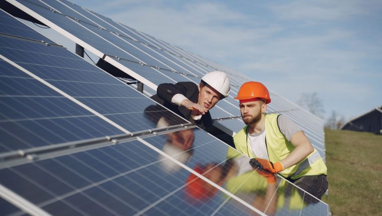 electricians inspecting the solar panels