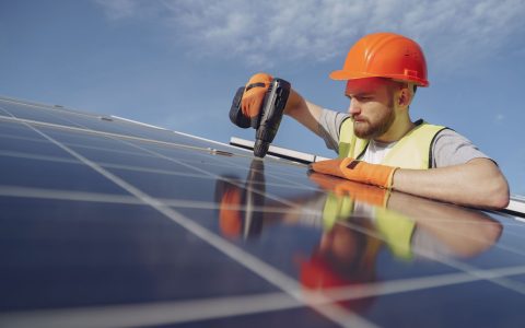 an electrician installing a solar panel