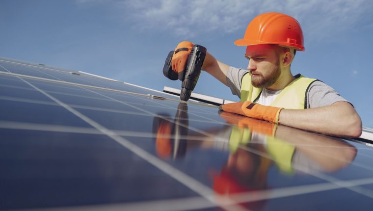 an electrician installing a solar panel