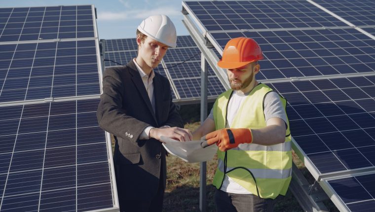 electricians inspecting the solar panels