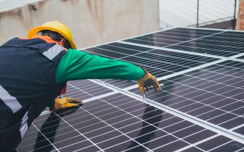 solar technician installing solar panel