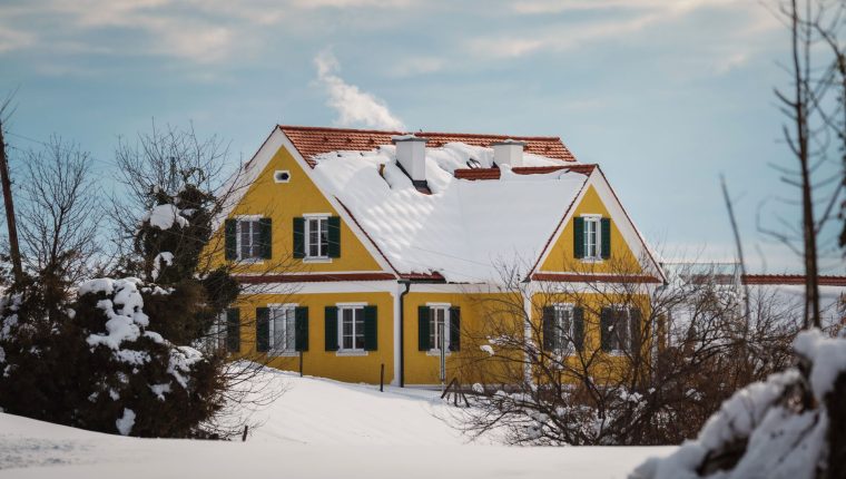 charming snow covered yellow house in austria