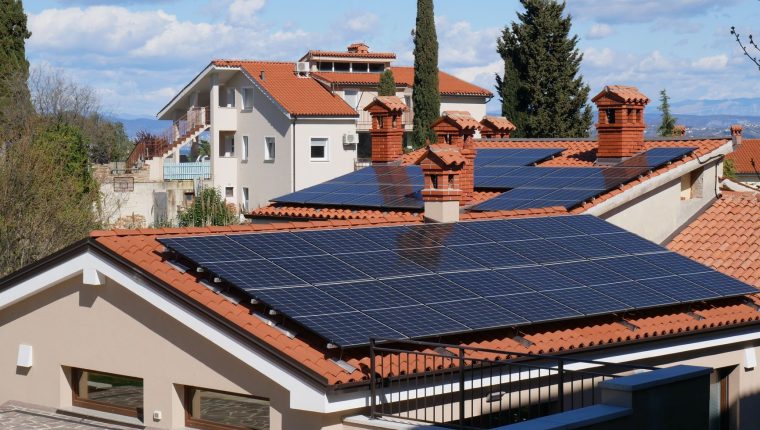 modern solar powered homes with red tile roofs