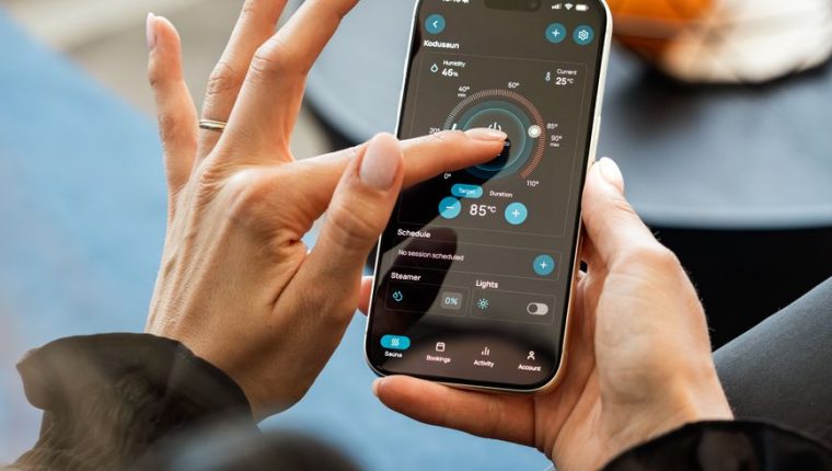 woman using mobile app to control sauna settings