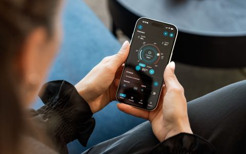 woman using mobile sauna control app indoors