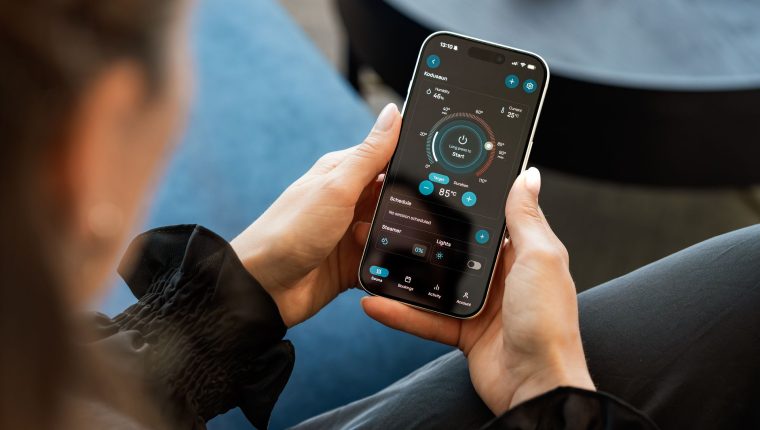 woman using mobile sauna control app indoors