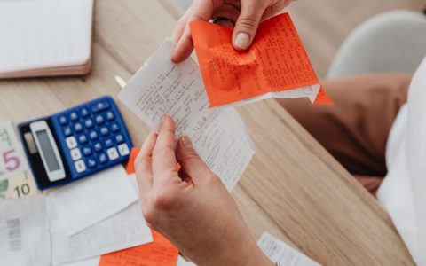 hands holding receipt and notes