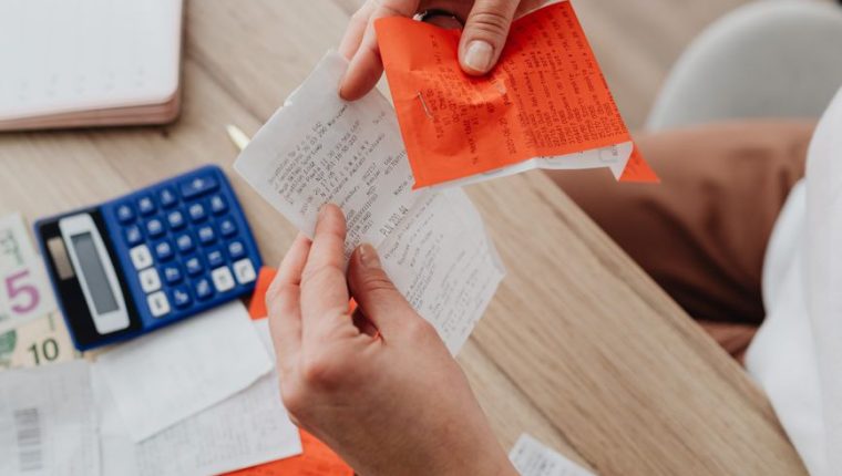 hands holding receipt and notes