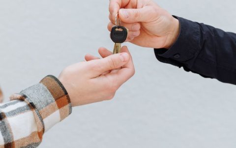 a person handing out a key
