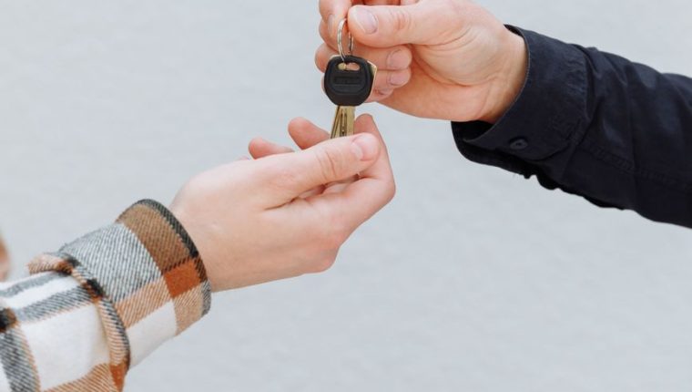 a person handing out a key