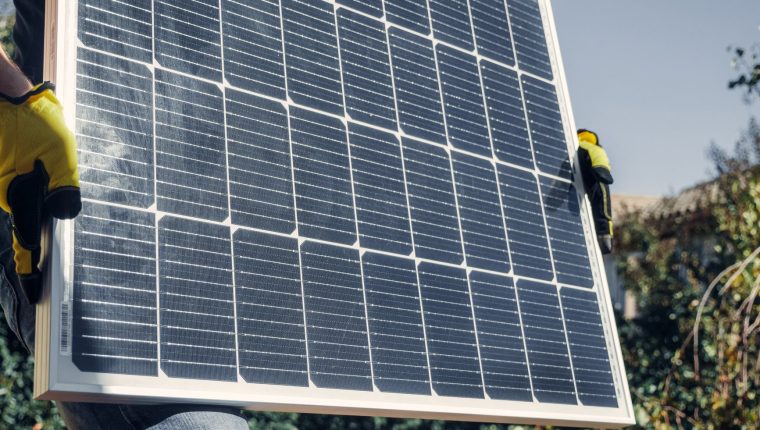 person holding a solar panel