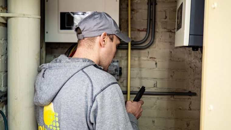 technician inspecting solar power equipment indoors