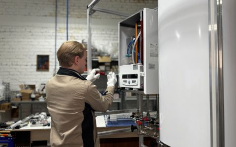 technician maintaining heating system in workshop