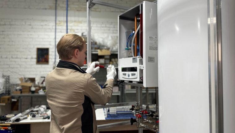 technician maintaining heating system in workshop