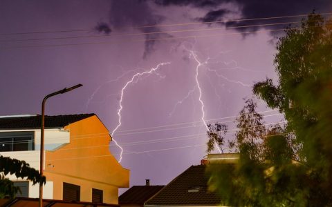 dramatic lightning over ayvalik homes at night