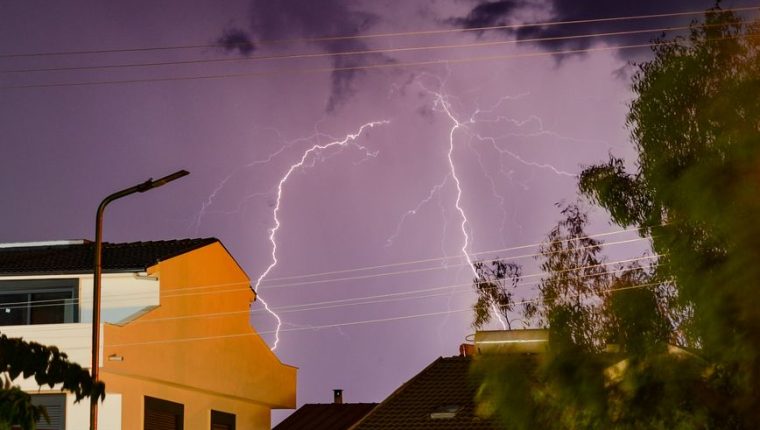 dramatic lightning over ayvalik homes at night