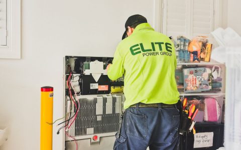 technician installing home battery system indoors