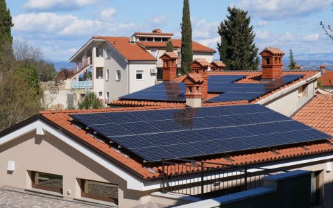 modern solar powered homes with red tile roofs